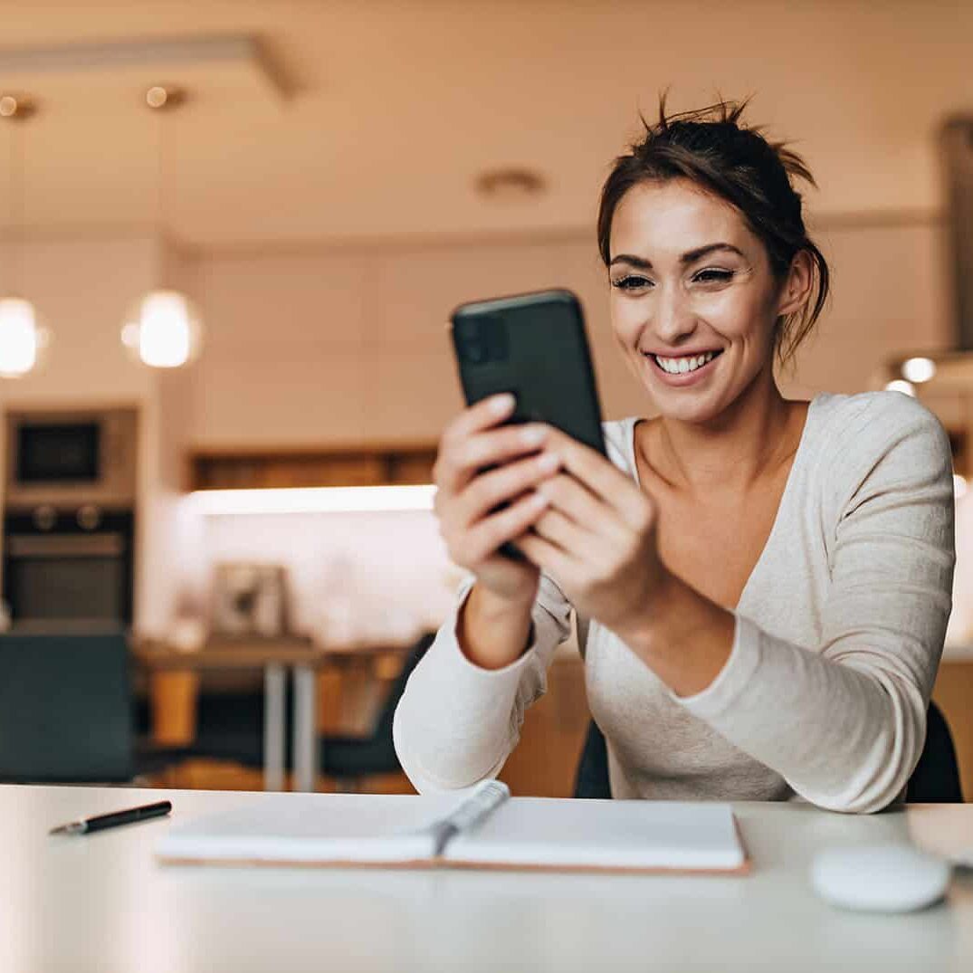 Female chatting with someone, enjoying at home.